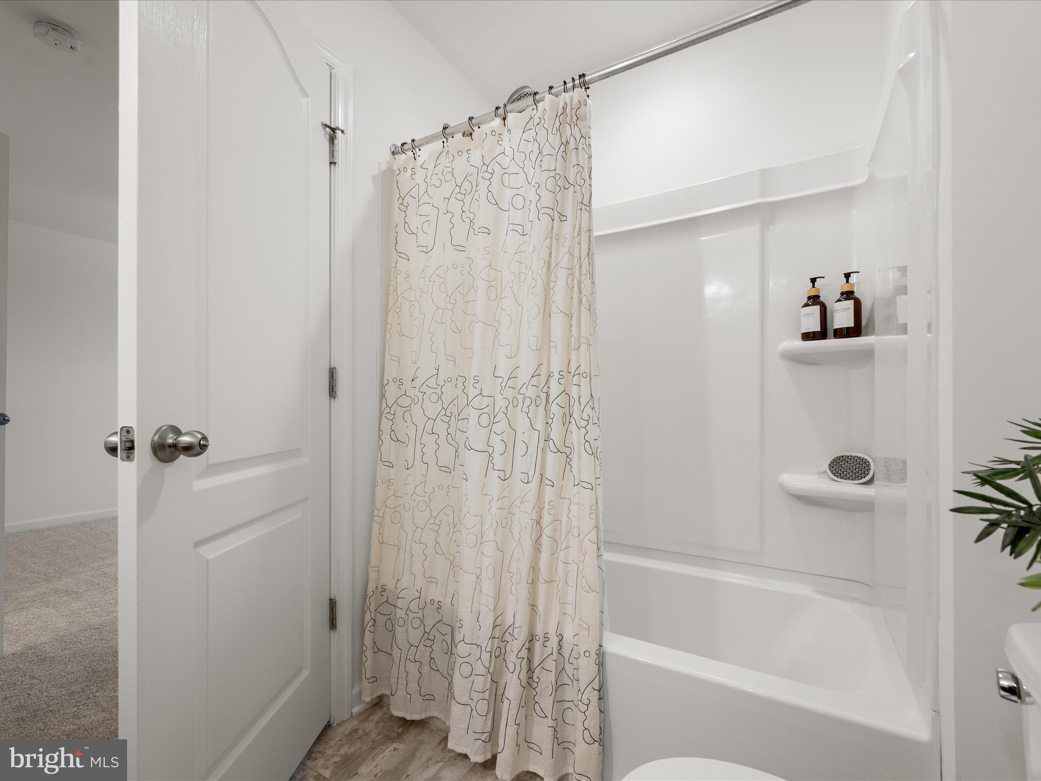 576 Thumper Drive Ranson, WV 25438 - Photo 25 of 37 a bathroom with a shower curtain and a sink