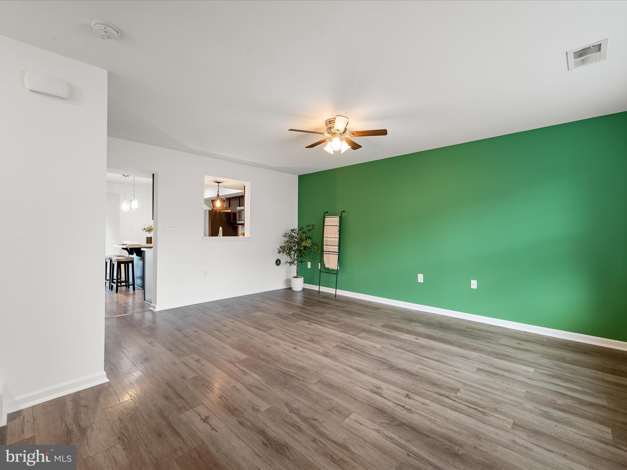 576 Thumper Drive Ranson, WV 25438 - Photo 7 of 37 a view of an empty room with window and wooden floor
