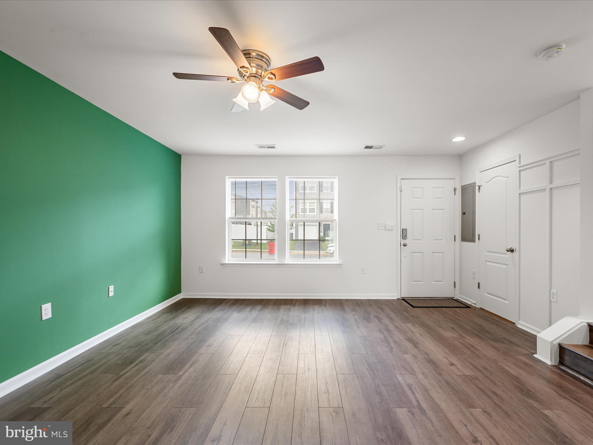 576 Thumper Drive Ranson, WV 25438 - Photo 8 of 37 a view of an empty room with wooden floor and a window