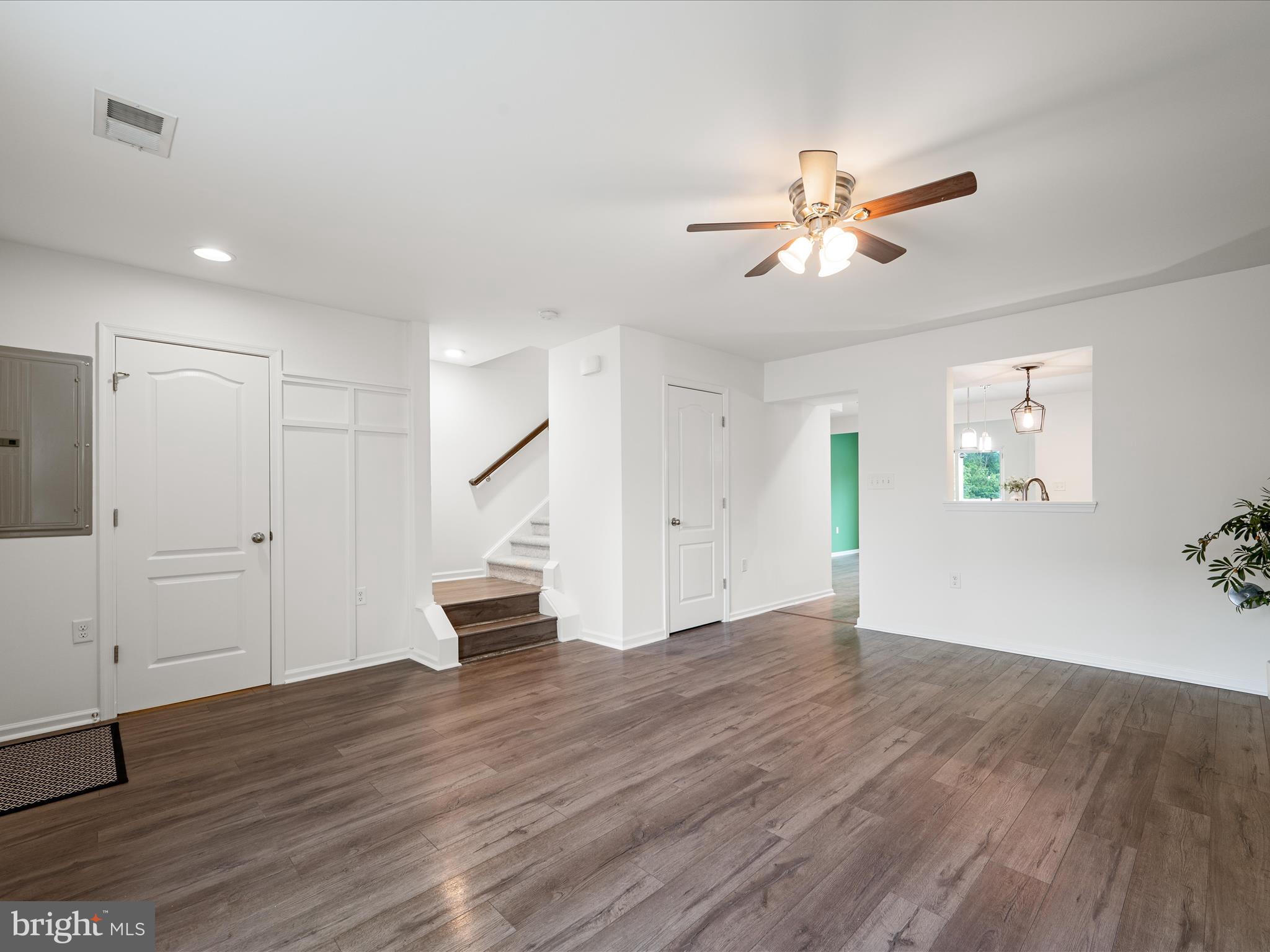576 Thumper Drive Ranson, WV 25438 - Photo 9 of 37 a view of an empty room with wooden floor and a ceiling fan