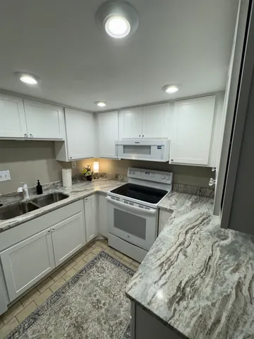 a kitchen with a sink stove and cabinets