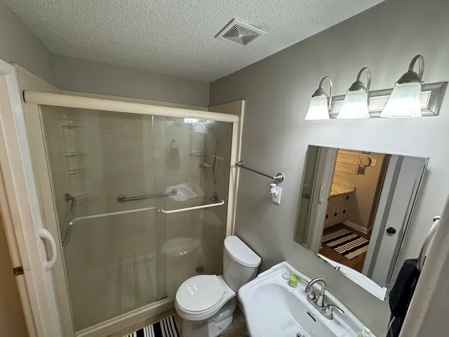 a bedroom with a bed and cabinets