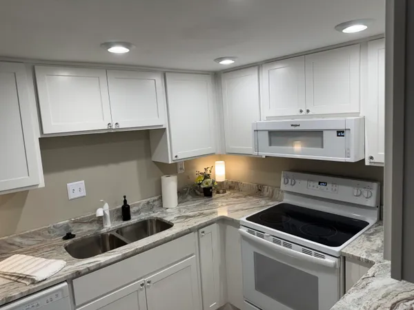 a kitchen with a sink a stove and cabinets