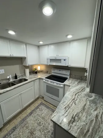 a kitchen with a sink stove and cabinets