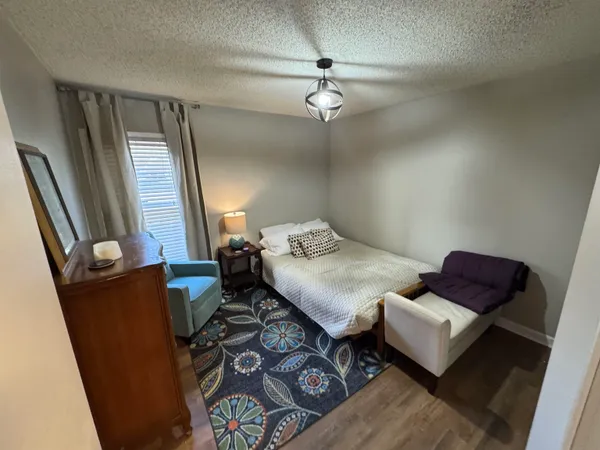 a bedroom with furniture and wooden floor
