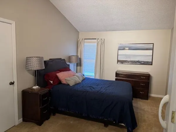 a bedroom with a bed and cabinets