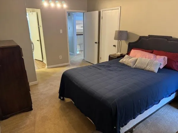 a bedroom with a bed and a mirror