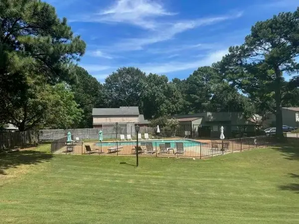 a view of house with a yard