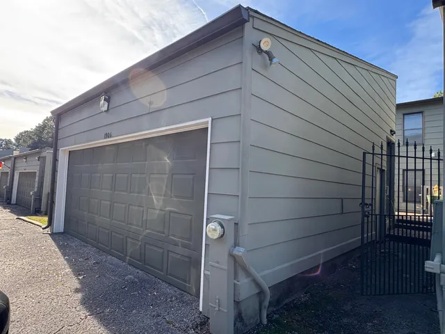 a view of a wooden door and brick wall