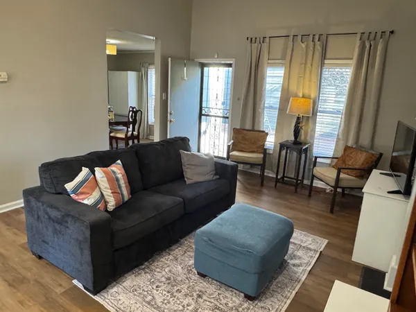 a living room with furniture and a large window