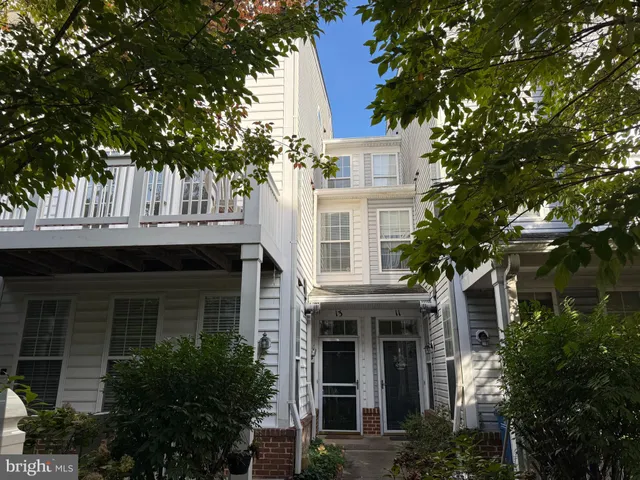 a front view of a house with a tree