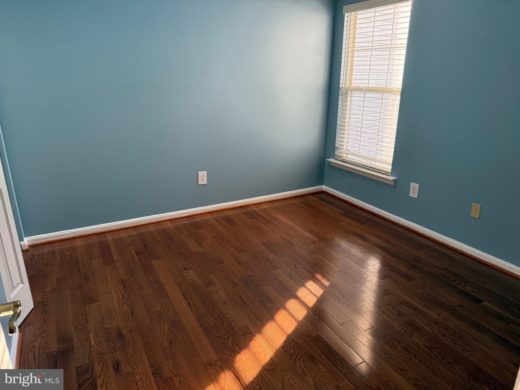 13 Crusader Court Germantown, MD 20874 - Photo 11 of 20 an empty room with wooden floor and windows