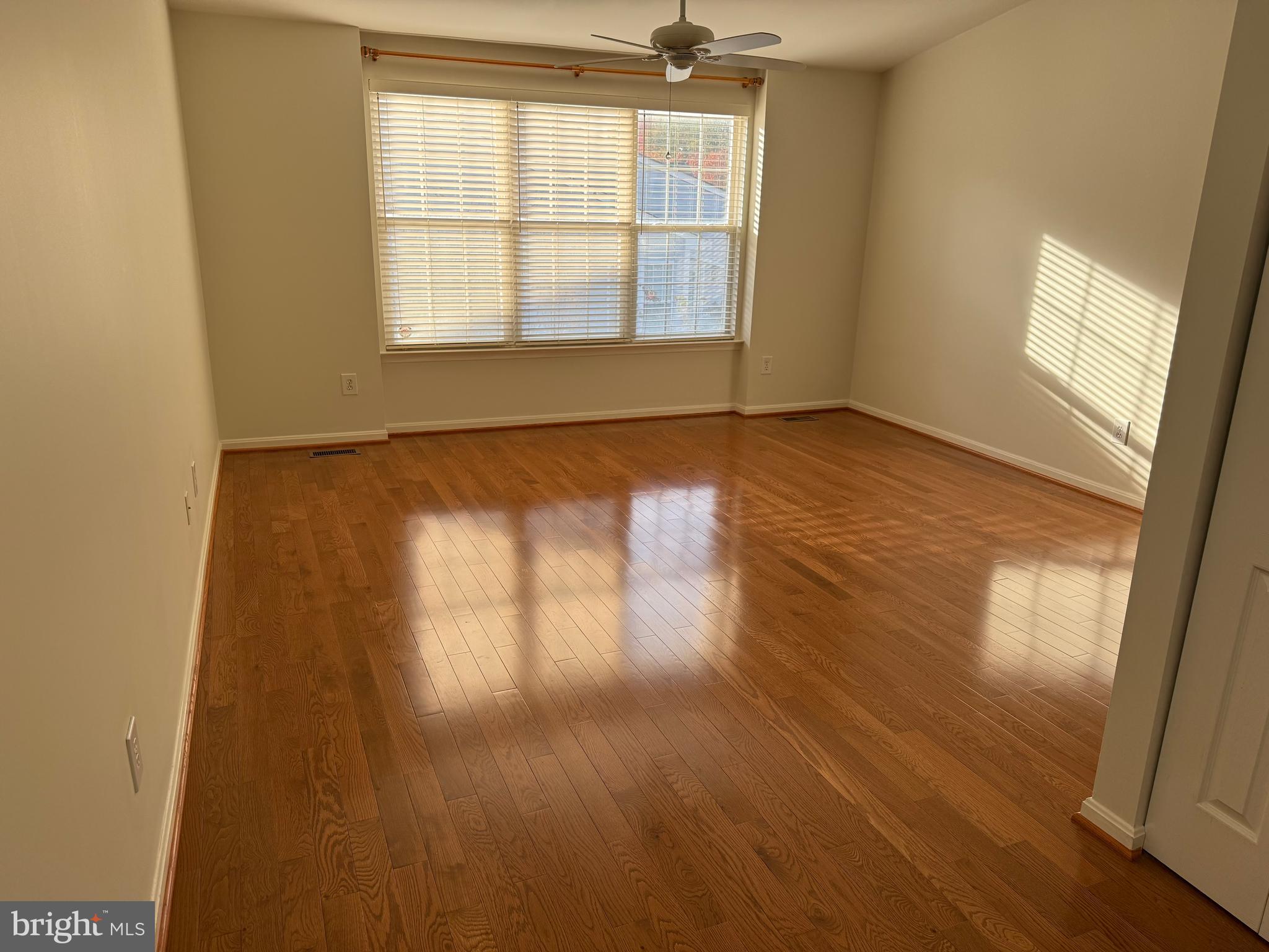 13 Crusader Court Germantown, MD 20874 - Photo 16 of 20 an empty room with wooden floor and windows