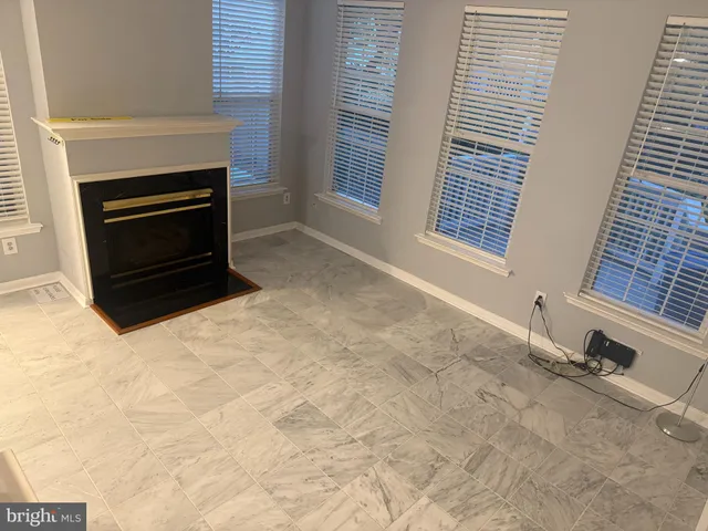 a view of an empty room with a fireplace