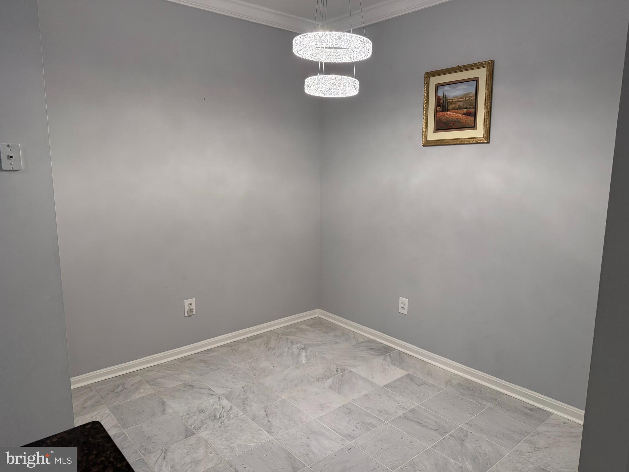 13 Crusader Court Germantown, MD 20874 - Photo 8 of 20 an empty room with a chandelier fan