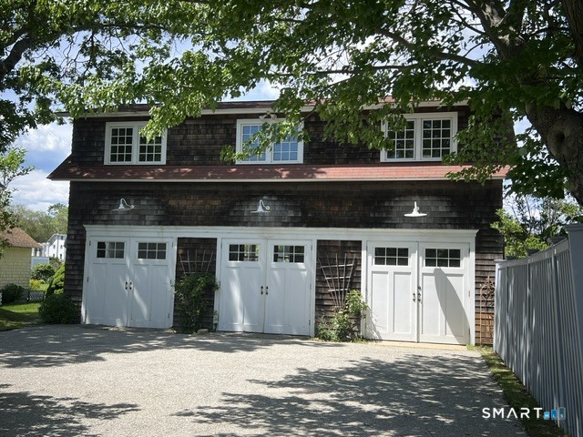 153 Middle Beach Road Madison, CT 06443 - Photo 25 of 40 On the entry level of the detached guest house there is a one-car garage, a large storage area with a large stackable washer/dryer