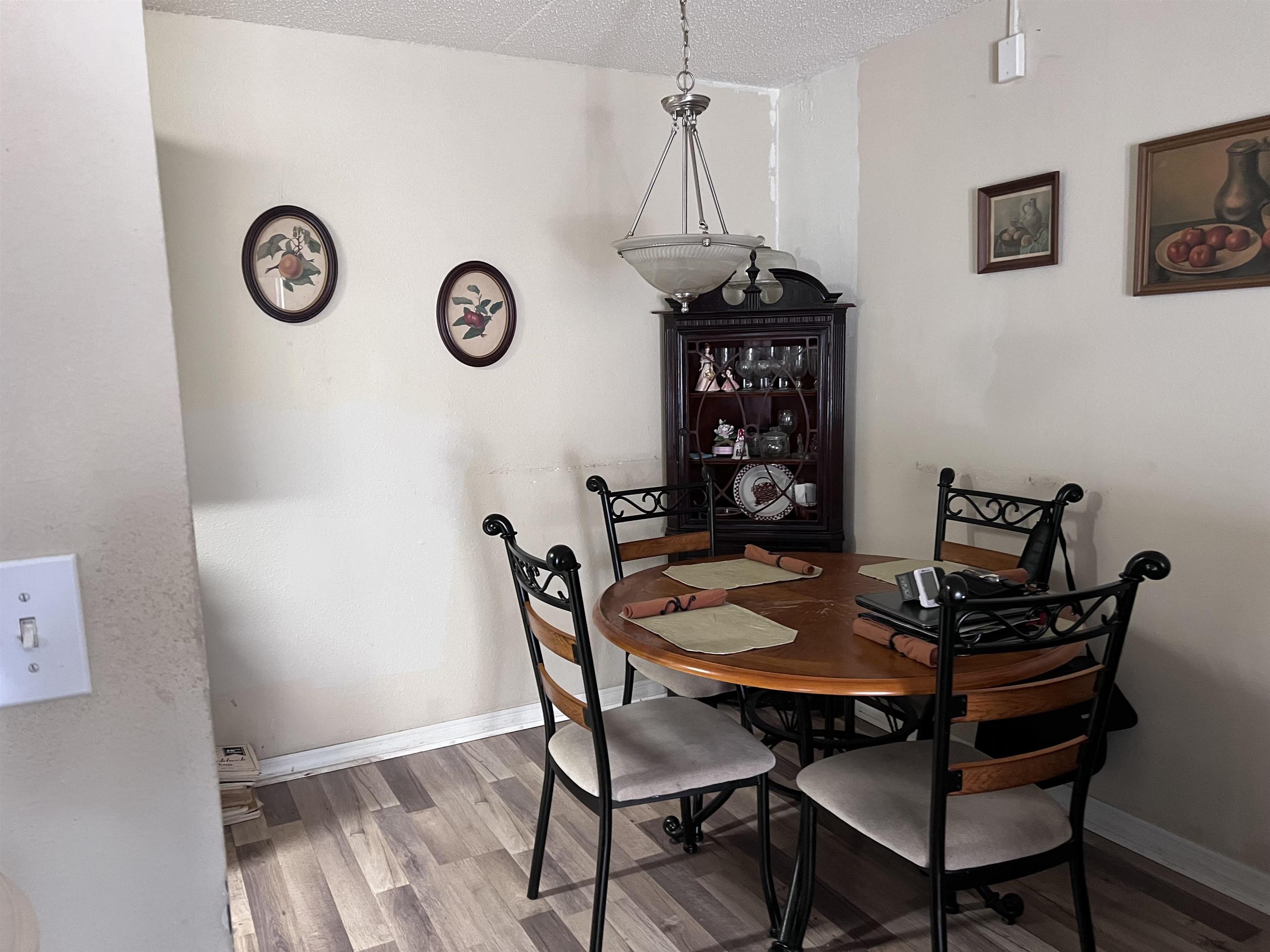 355 Monument Road, Unit 10D1 Jacksonville, FL 32225 - Photo 8 of 21 a view of a dining room with furniture and wooden floor