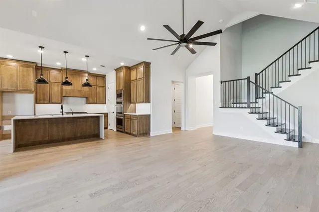 a view of a kitchen with a sink stainless steel appliances and cabinets