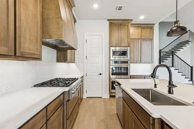 a kitchen that has a sink and a stove