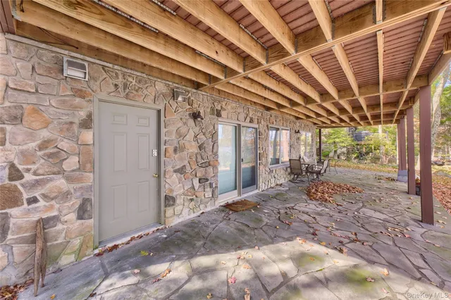 a view of a hallway with wooden walls