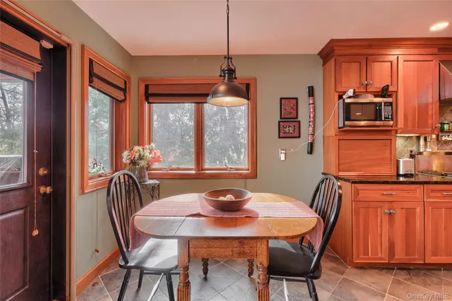 a view of a dining room with furniture and window