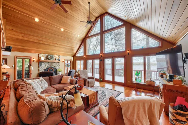 a living room with furniture a fireplace and a large window