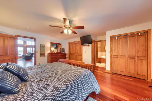 a spacious bedroom with a large bed and a chandelier