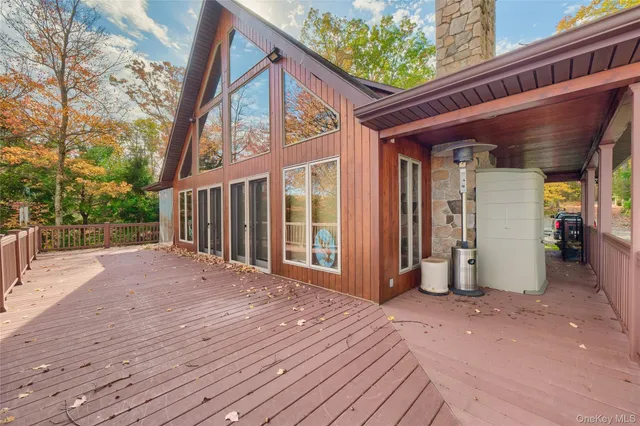 a view of a house with a wooden bench