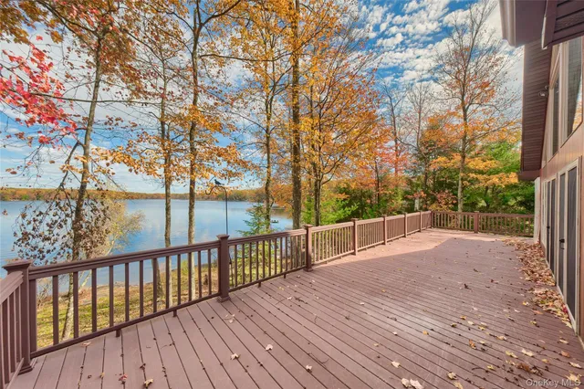 a view of balcony with wooden floor and fence