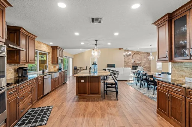 a large kitchen with kitchen island a large island in the center