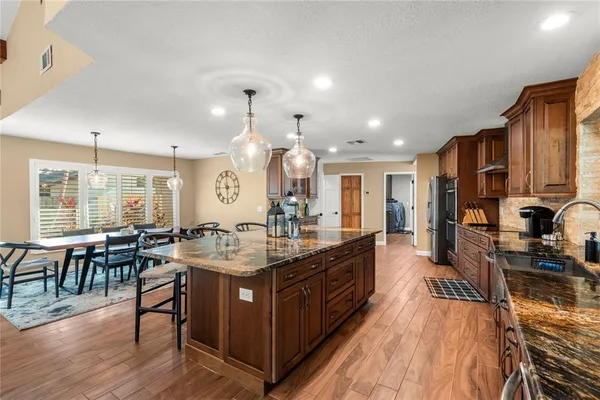 a utility room with granite countertop a sink and washing machine