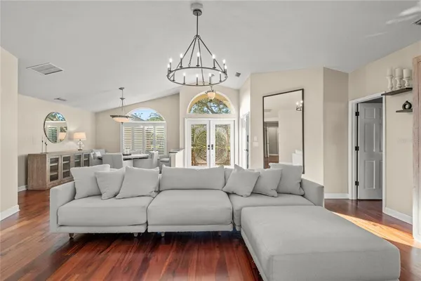 a bedroom with a bed and a chandelier