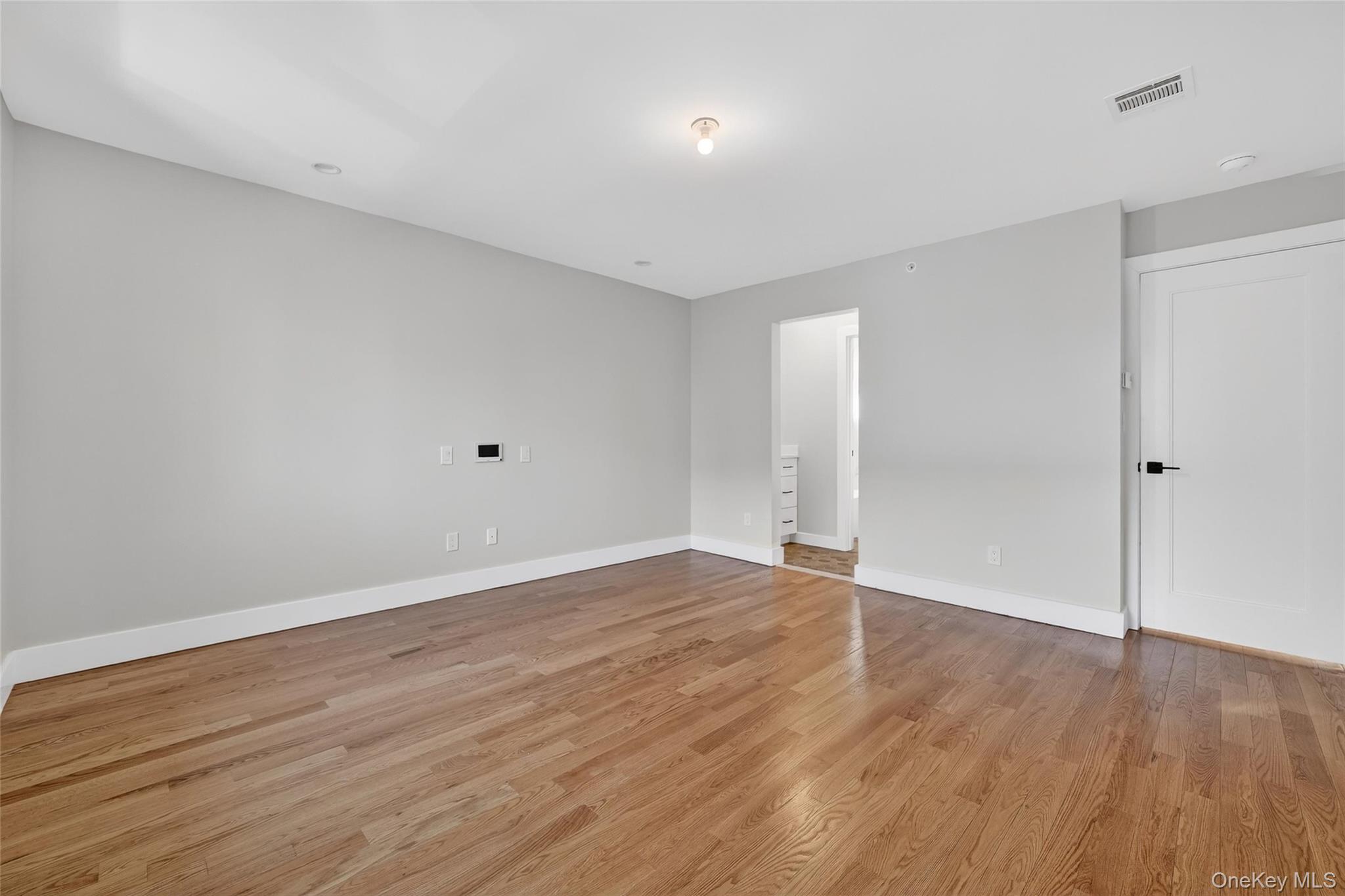 35 South Cole Avenue, Unit 202 Spring Valley, NY 10977 - Photo 27 of 50 a view of an empty room with wooden floor