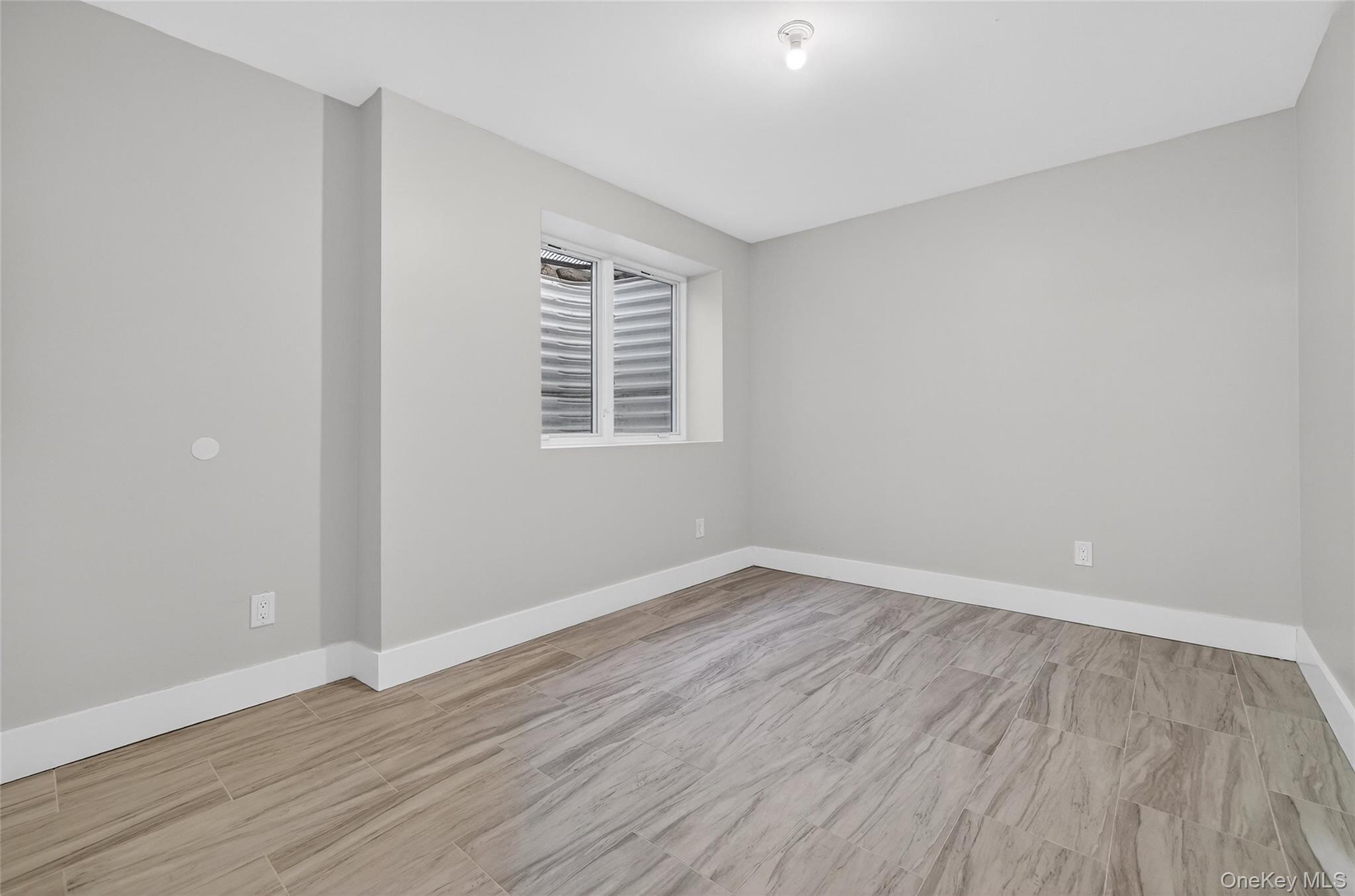 35 South Cole Avenue, Unit 202 Spring Valley, NY 10977 - Photo 45 of 50 wooden floor in an empty room with a window