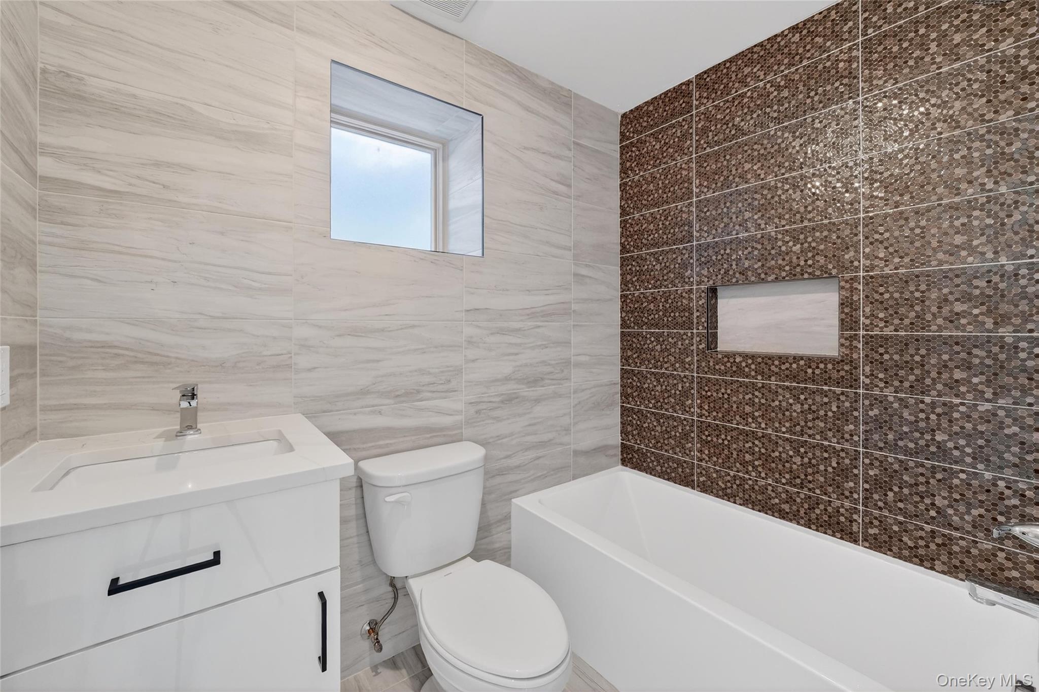 35 South Cole Avenue, Unit 202 Spring Valley, NY 10977 - Photo 46 of 50 a bathroom with a sink toilet and bathtub