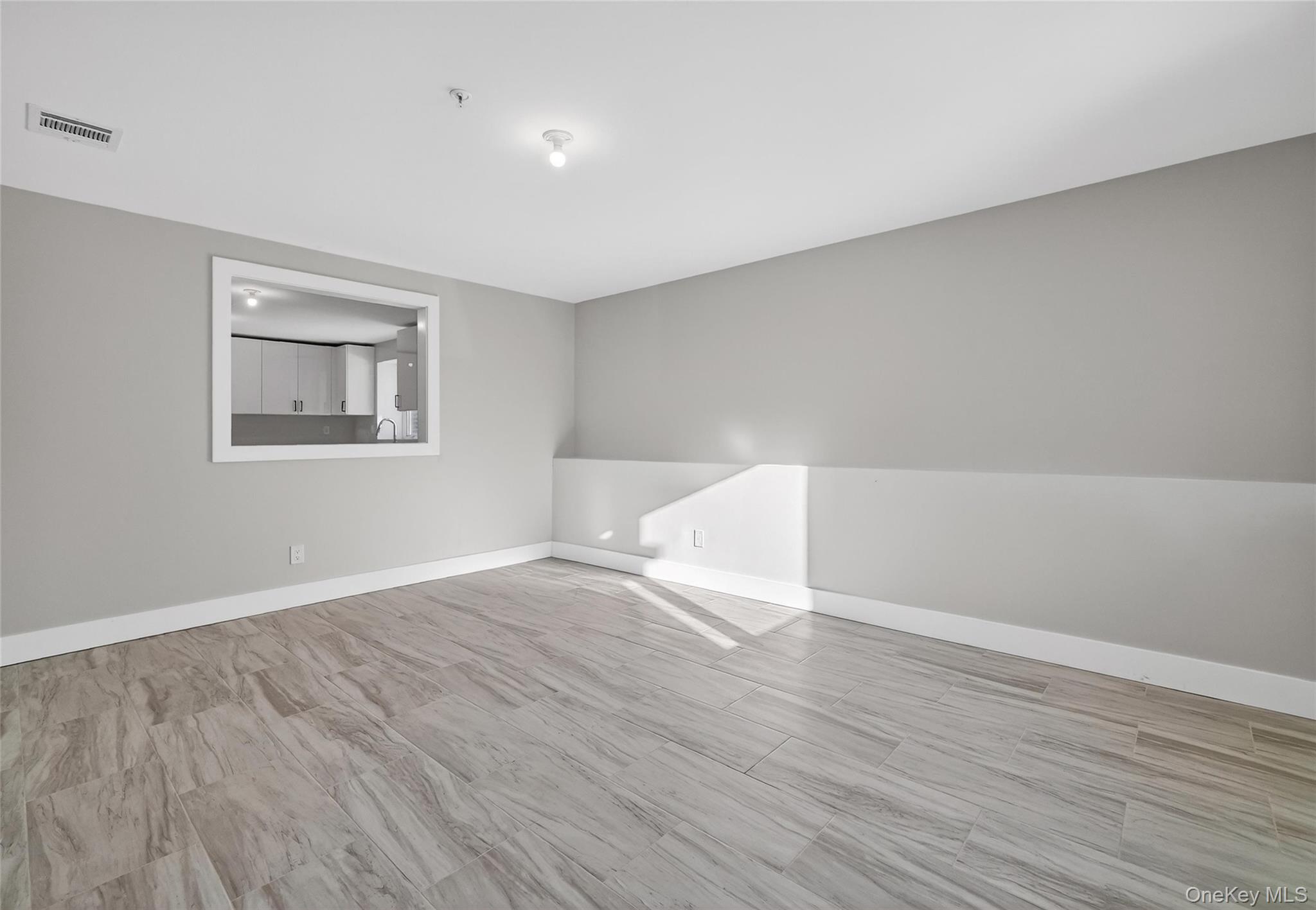 35 South Cole Avenue, Unit 202 Spring Valley, NY 10977 - Photo 50 of 50 a view of an empty room with wooden floor and a window