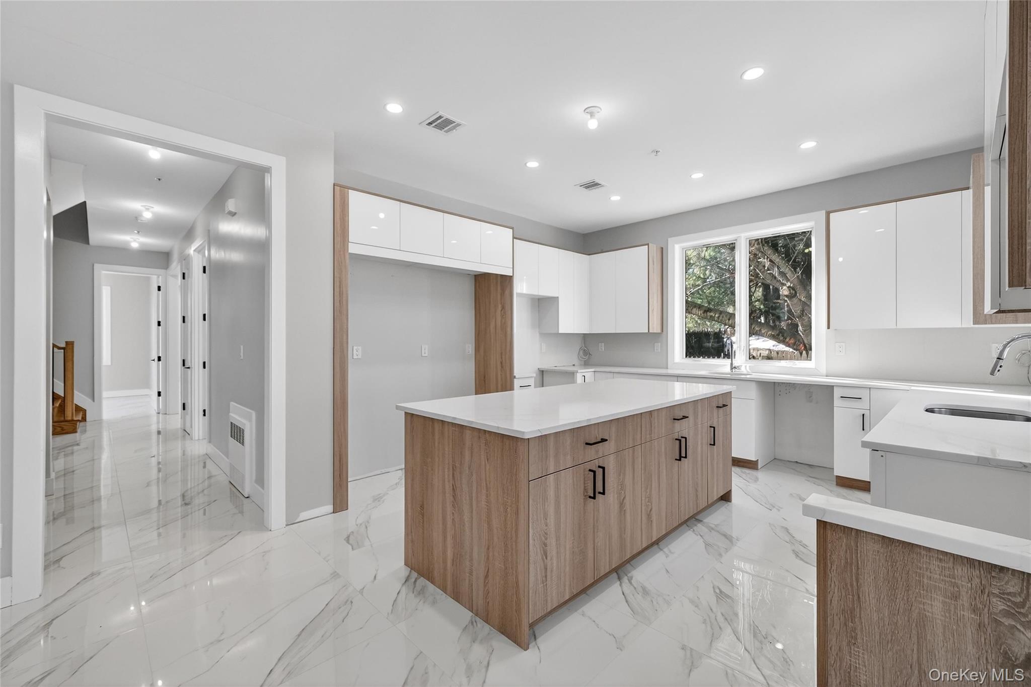 35 South Cole Avenue, Unit 202 Spring Valley, NY 10977 - Photo 6 of 50 a large kitchen with a stove a sink a refrigerator and a cabinets