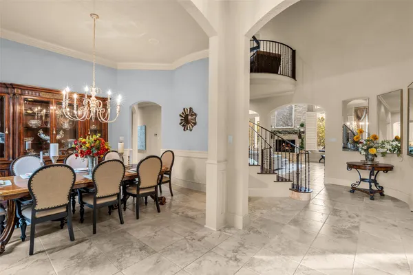a view of a dining room with furniture and chandelier