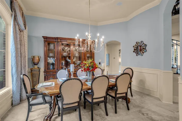 a dining room with furniture and chandelier kitchen view
