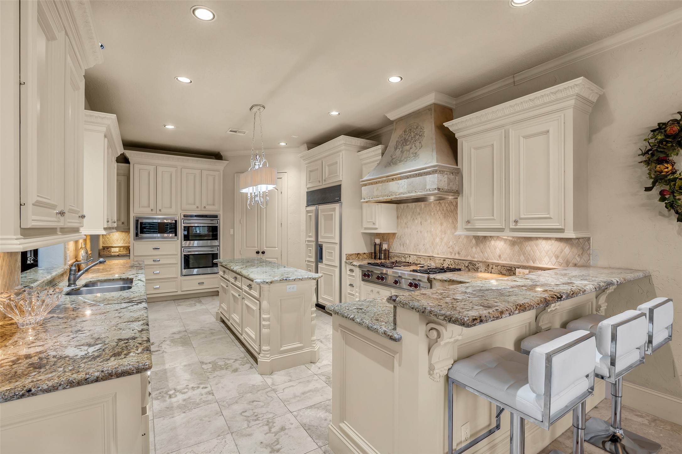 75 South Player Crest Circle Spring, TX 77382 - Photo 14 of 39 a kitchen with stainless steel appliances granite countertop a stove top oven a sink a refrigerator and white cabinets