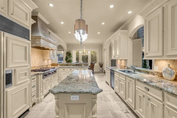 a kitchen with stainless steel appliances granite countertop stove top oven and cabinets
