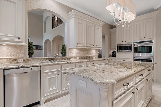 a spacious bathroom with a double vanity sink a mirror a bathtub and a shower