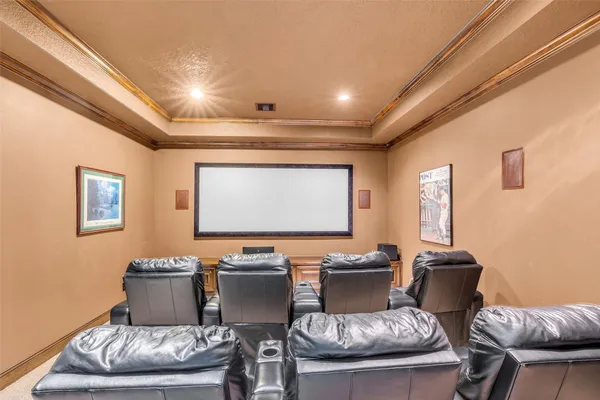 a room with furniture a projector and screen