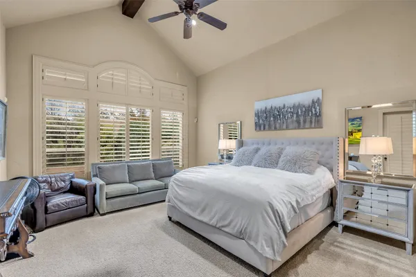 a bedroom with a bed a couch and dresser