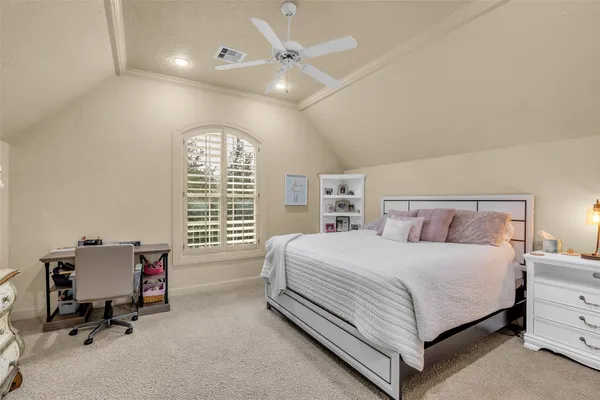 a bedroom with a bed and a chair