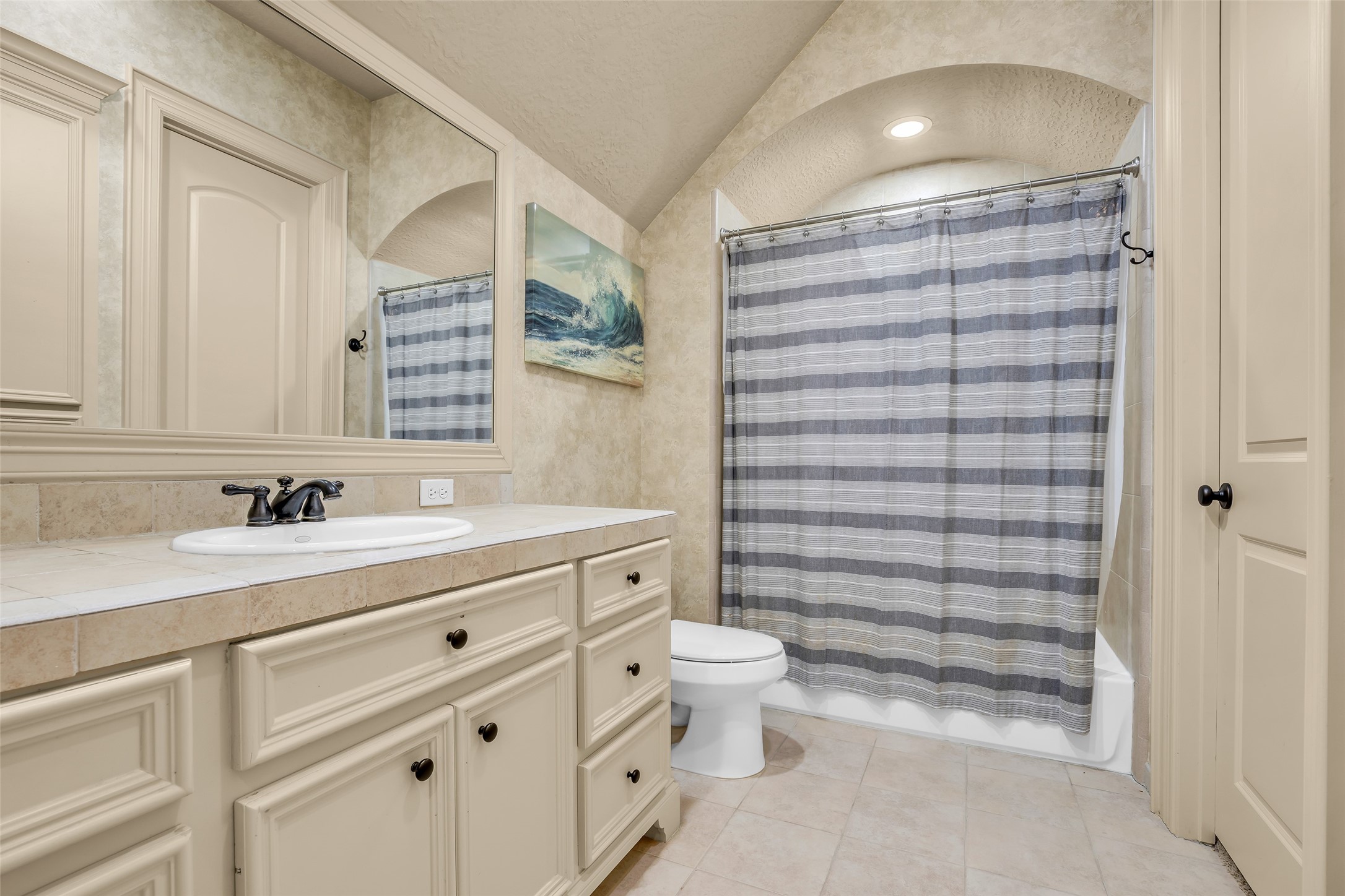 75 South Player Crest Circle Spring, TX 77382 - Photo 34 of 39 a bathroom with a toilet a sink a mirror and a shower