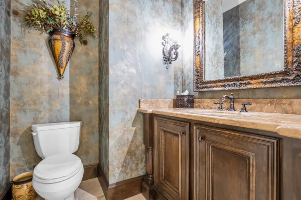 a bathroom with a toilet sink and mirror