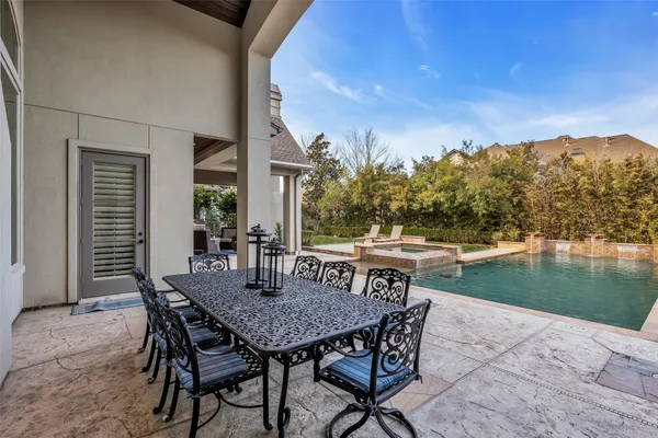 a view of a patio with a table and chairs
