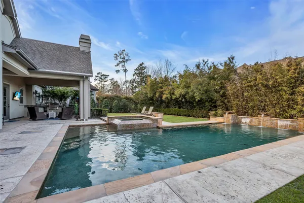 a view of a swimming pool with a yard
