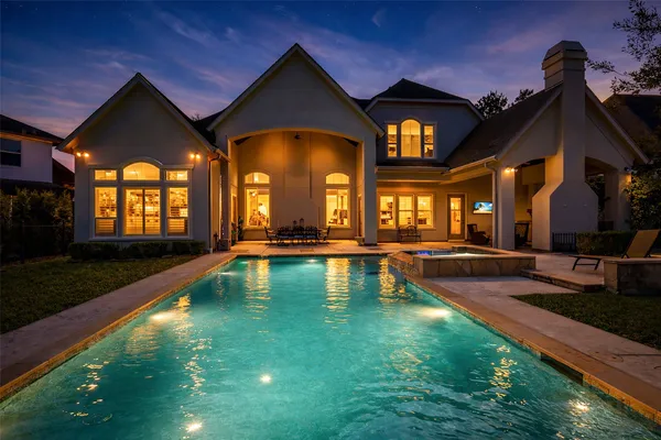 a view of a house with swimming pool and a yard